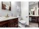 Bathroom showcasing a dark wood vanity with double sinks and modern fixtures at 4520 E 112Th Pl, Thornton, CO 80233