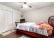 Bedroom featuring a wood sleigh bed, ceiling fan, and double door closet at 4520 E 112Th Pl, Thornton, CO 80233
