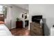 Bedroom with modern furnishings, wood floors, and a view into the bathroom at 4520 E 112Th Pl, Thornton, CO 80233
