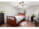 Cozy bedroom with a sleigh bed, ceiling fan, and wood flooring at 4520 E 112Th Pl, Thornton, CO 80233
