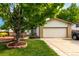Charming home with a well-manicured lawn, mature shade tree, and a welcoming two-car garage at 4520 E 112Th Pl, Thornton, CO 80233