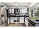 Modern kitchen featuring stainless steel appliances, white cabinets, and granite countertops at 4520 E 112Th Pl, Thornton, CO 80233