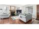 Cozy living room featuring a wood-burning fireplace, wood floors, and lots of natural light at 4520 E 112Th Pl, Thornton, CO 80233