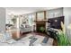 Inviting living room with fireplace, wood floors, and open layout to the dining area at 4520 E 112Th Pl, Thornton, CO 80233