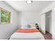 Cozy bedroom featuring a comfortable bed, closet space, and a well-lit window with natural light at 5993 Oneida St, Commerce City, CO 80022
