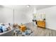 Spacious living room featuring hardwood floors, ample natural light, and stylish furnishings at 5993 Oneida St, Commerce City, CO 80022