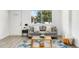 Bright living room with large window, comfortable seating, and stylish decor at 5993 Oneida St, Commerce City, CO 80022