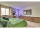 This stylish bedroom features sleek, modern furnishings and a comfortable green bedspread, perfect for relaxation at 17595 E Mansfield Ave # 1331L, Aurora, CO 80013