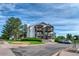 Exterior view of a multi-story condo with balconies and well-maintained landscaping at 17595 E Mansfield Ave # 1331L, Aurora, CO 80013
