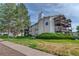 Exterior view of the multi-story condo building with beautiful landscaping and trees at 17595 E Mansfield Ave # 1331L, Aurora, CO 80013