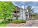 A low-angle exterior view of a multi-story condo with private balconies at 17595 E Mansfield Ave # 1331L, Aurora, CO 80013
