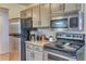 Updated kitchen with stainless steel appliances and modern countertops at 17595 E Mansfield Ave # 1331L, Aurora, CO 80013