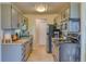 Kitchen with gray cabinetry, modern appliances, and laminate countertops at 17595 E Mansfield Ave # 1331L, Aurora, CO 80013
