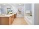 Well-lit bathroom with double sinks and a soaking tub at 2410 Morningview Ln, Castle Rock, CO 80109