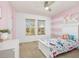 Bright bedroom with horizontal pink stripes, white furniture, and a ceiling fan at 2410 Morningview Ln, Castle Rock, CO 80109