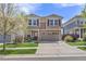 Two-story home showcasing great curb appeal, a two-car garage, and manicured lawn at 2410 Morningview Ln, Castle Rock, CO 80109