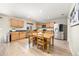 Eat-in kitchen features stainless appliances, wood cabinets, and wood flooring at 2410 Morningview Ln, Castle Rock, CO 80109