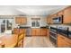 Well-lit kitchen with wood cabinets, stainless steel appliances, and backyard access at 2410 Morningview Ln, Castle Rock, CO 80109