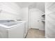 Bright laundry room equipped with washer, dryer, and wire shelving at 2410 Morningview Ln, Castle Rock, CO 80109