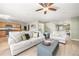 Bright, open concept living room with fireplace, ceiling fan and wood floors at 2410 Morningview Ln, Castle Rock, CO 80109