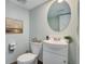 Bathroom featuring a modern vanity, toilet, stylish mirror, and fresh decor at 4410 S Estes St, Littleton, CO 80123