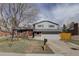 Charming two-story home with gray siding, brick accents, and a well-kept lawn at 4410 S Estes St, Littleton, CO 80123