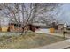 Charming home with a two-car garage, brick facade, and mature tree at 4410 S Estes St, Littleton, CO 80123