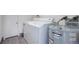 Functional laundry area with a washing machine, dryer, and hot water tank for added convenience at 4410 S Estes St, Littleton, CO 80123