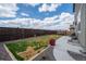 Spacious backyard featuring lush grass, mature trees, a trampoline, and a concrete patio area at 14651 Dahlia Way, Thornton, CO 80602