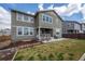 Large backyard with a patio, seating, grill, and landscaped areas for relaxation and recreation at 14651 Dahlia Way, Thornton, CO 80602