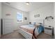 Bright bedroom features a large window, white furniture and a fun beach-themed bedding set at 14651 Dahlia Way, Thornton, CO 80602