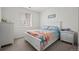 Comfortable bedroom with nautical-themed bedding, and a large window at 14651 Dahlia Way, Thornton, CO 80602