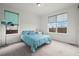 Bright bedroom with a large window, carpet floors, and light blue polka dot bedding at 14651 Dahlia Way, Thornton, CO 80602