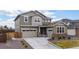 Beautiful exterior showcasing a two-car garage, complemented by a well-maintained lawn at 14651 Dahlia Way, Thornton, CO 80602