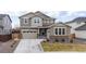 Charming two-story home featuring a manicured lawn, neutral color palette, and attached two-car garage at 14651 Dahlia Way, Thornton, CO 80602