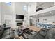Cozy living space adjacent to modern kitchen, featuring a fireplace, hardwood floors at 14651 Dahlia Way, Thornton, CO 80602