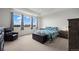 Relaxing primary bedroom with sitting area, tray ceiling, and a large window at 14651 Dahlia Way, Thornton, CO 80602