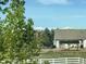 Backyard featuring a patio area with an outdoor kitchen/dining area, mountain views, and a white fence at 8700 Ehler Pkwy, Brighton, CO 80602