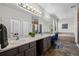 Bright bathroom showcasing a double vanity, soaking tub and glass-enclosed shower at 8700 Ehler Pkwy, Brighton, CO 80602