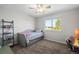 Bedroom with a single bed, ladder shelf, and a large window with neighborhood views at 8700 Ehler Pkwy, Brighton, CO 80602