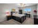 Bedroom with dark furniture, a ceiling fan, and a window with neighborhood views at 8700 Ehler Pkwy, Brighton, CO 80602