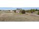 Charming two-story home with stone accents, mature trees and a spacious front yard, enclosed by a white fence at 8700 Ehler Pkwy, Brighton, CO 80602