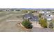 Beautiful two-story home featuring a well-manicured lawn and a charming front porch, set within a large fenced lot at 8700 Ehler Pkwy, Brighton, CO 80602