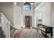 Spacious foyer with grand staircase, a large arched window, and stylish seating area at 8700 Ehler Pkwy, Brighton, CO 80602