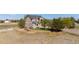 Landscaped front yard featuring mature trees, lush green lawn, and tiered brick retaining wall at 8700 Ehler Pkwy, Brighton, CO 80602