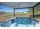 Covered hot tub with clear water and views of the property, white fence and distant mountains at 8700 Ehler Pkwy, Brighton, CO 80602