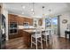 Gourmet kitchen features custom cabinets, stainless steel appliances, granite countertops, and breakfast bar at 8700 Ehler Pkwy, Brighton, CO 80602