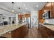 Spacious kitchen features custom cabinets, stainless steel appliances, granite countertops, and breakfast bar at 8700 Ehler Pkwy, Brighton, CO 80602