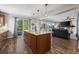 Open kitchen with island, granite countertops, stainless steel sink, and outdoor access to patio at 8700 Ehler Pkwy, Brighton, CO 80602