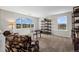 Bright living room with large arched window, comfortable seating, and natural light at 8700 Ehler Pkwy, Brighton, CO 80602